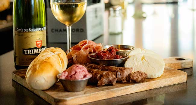 The antipasto platter served at DeBlaze at 131 restaurant and bar appetizer and starters menu features Italian sausage, prosciutto, cheese, chutney and mustard spread
