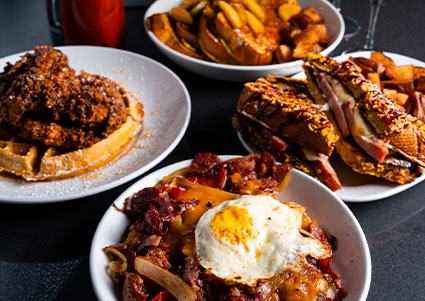 Four plates of comfort food served fresh at our steakhouse restaurant—perfect for bar snacks!.